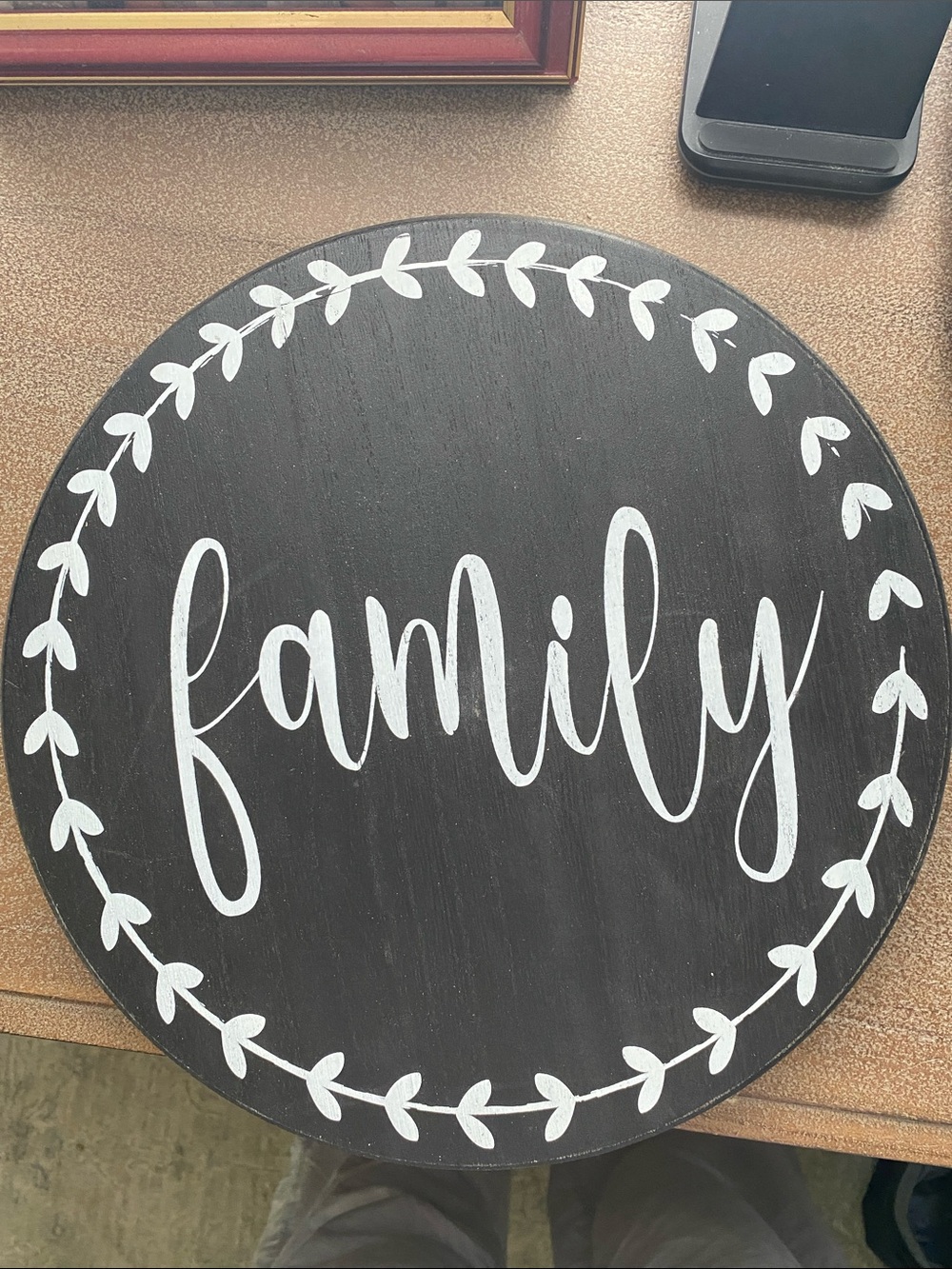 Black Round Wall Sign with White "family" Script